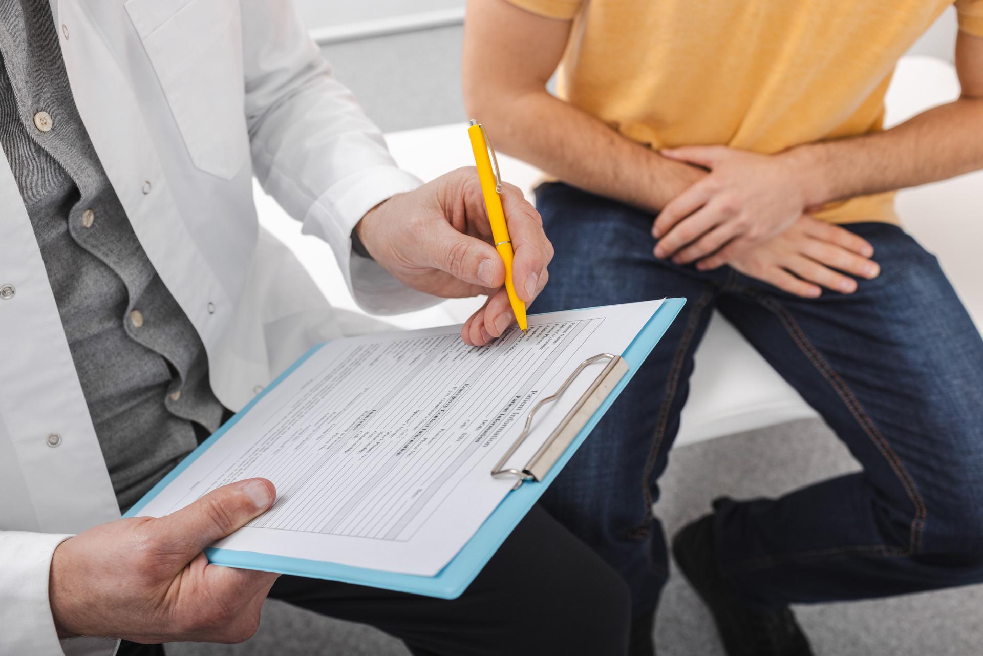 Doctor fills clipboard with patient's complaints about health of his reproductive system, potency disorder and sexual function. Andrology and urology