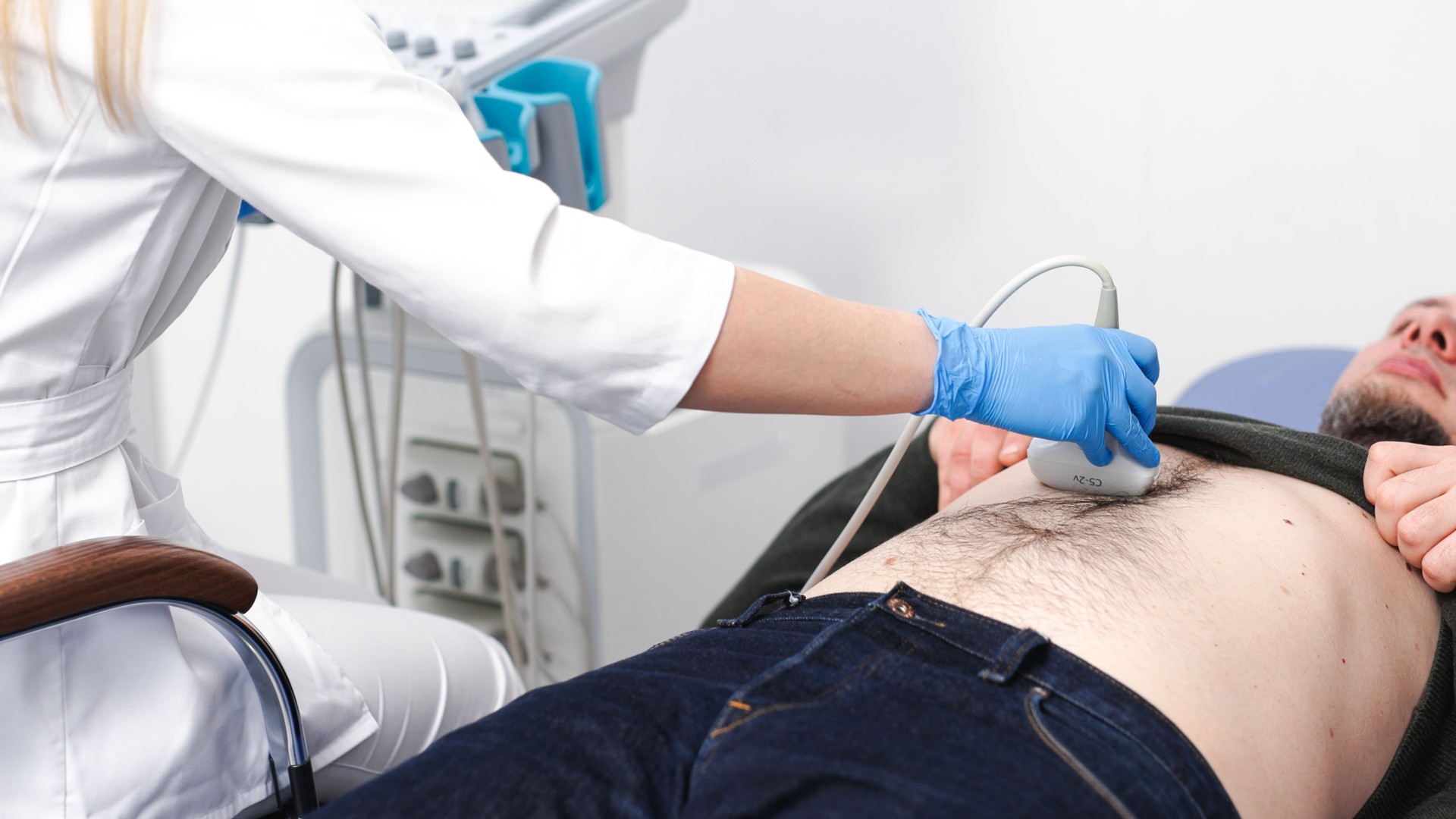 Ultrasound diagnosis of abdominal organs for a man in the clinic.